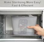 A translucent gray silicone sterilizer bag with printed measurement markings is being held inside a stainless steel microwave by a person's hand. Text at the top reads 'Make Sterilizing More Easy! Fast & Effecient'.