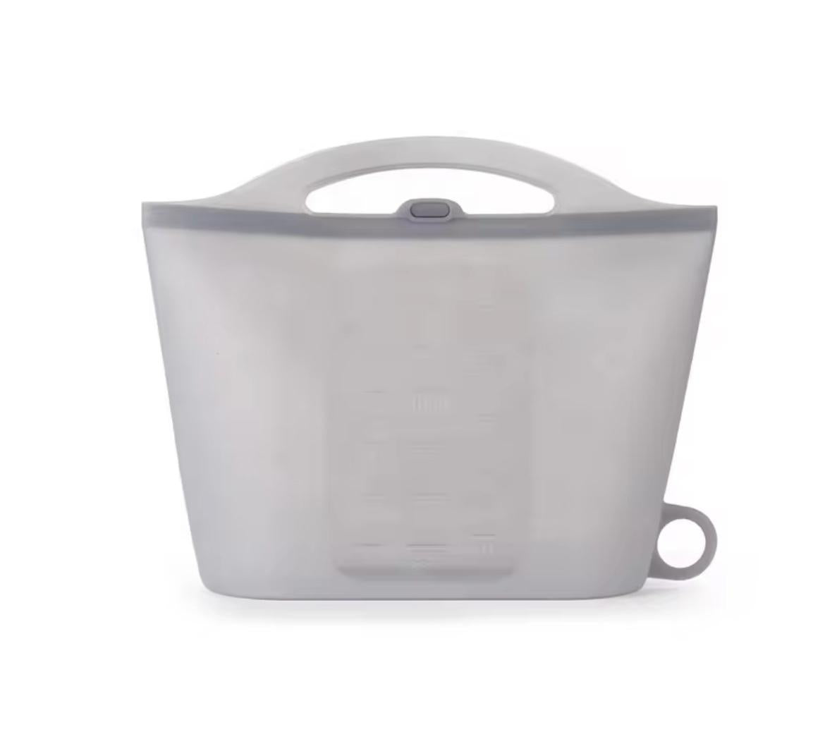 A translucent gray silicone collapsible water bottle with a handle and measurement markings, shown on a white background.
